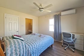 Primary bedroom with a walk in closet and ensuite bathroom