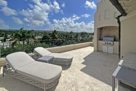 Lounge and barbecue area on L-shaped roof deck