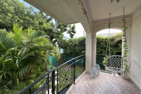 Back garden terrace surrounded by lush landscaping