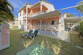 View of house and car port from back garden