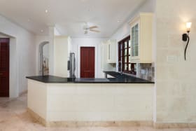 Large fitted kitchen leading to the laundry room