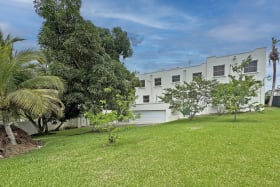 View of garage and lawn at back of house