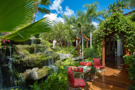 Beautiful gardens with waterfall lined with teak walkways