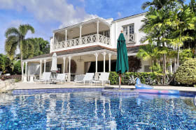 View of large swimming pool and house