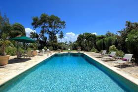 Idyllic pool terrace surrounded by tropical gardens