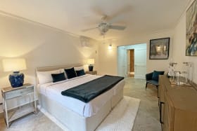 Bedroom with ceiling fans and AC