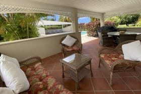 Covered verandah leads to swimming pool deck