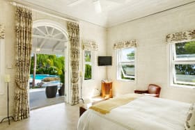 Ground floor bedroom opens to a balcony and swimming pool