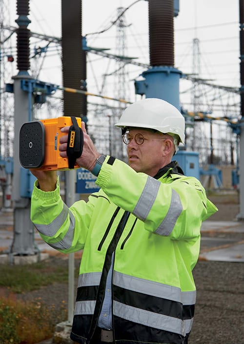 Technician holding Fluke acoustic imager