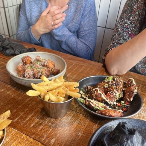 Crispy golden fries, crunchy fried chicken in glossy sauce with sesame seeds and green onions, and a bowl of shredded meat mixed with herbs and spices.
