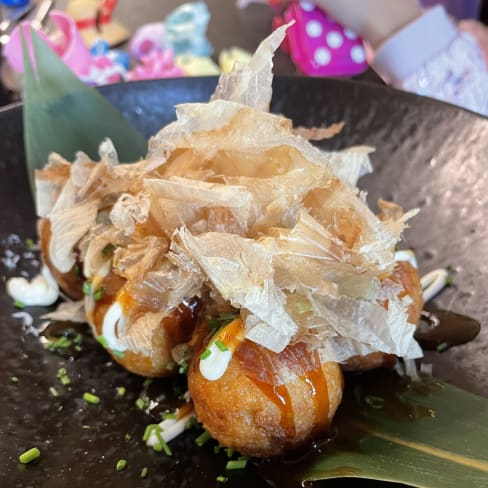 Bolas de takoyaki douradas e crocantes por fora, macias por dentro, regadas com um molho saboroso, cobertas com flocos de bonito e maionese cremosa, e polvilhadas com cebolinhas picadas.