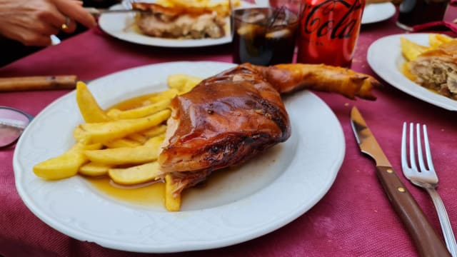 Portion of Roast Suckling Pig with Potatoes - Mesón Don Sancho, Segovia