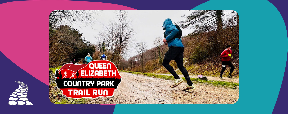 Back of a runner running along a dirt track with a raincoat
