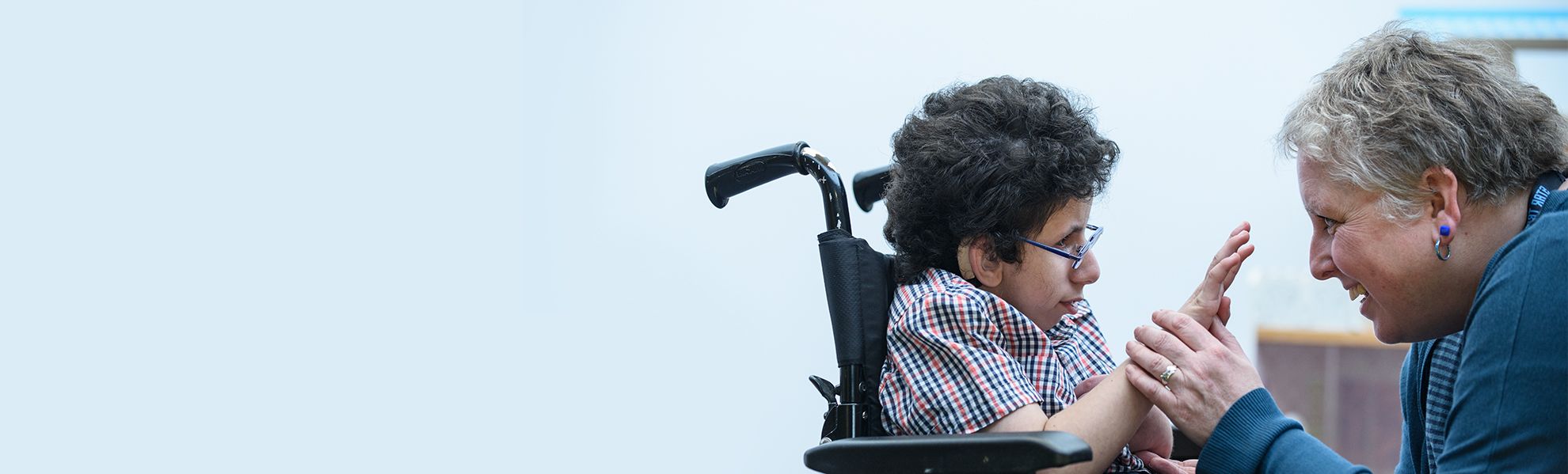 Nurse with boy in wheel chair