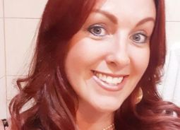 a white lady with red hair smiles at the camera