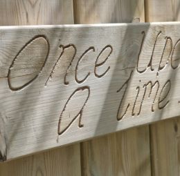 Wooden signpost with once upon a time etched into it