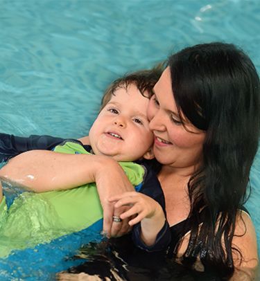 Boy and mum in swimming pool