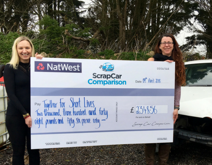 Scrap Car Challenge staff presenting cheque