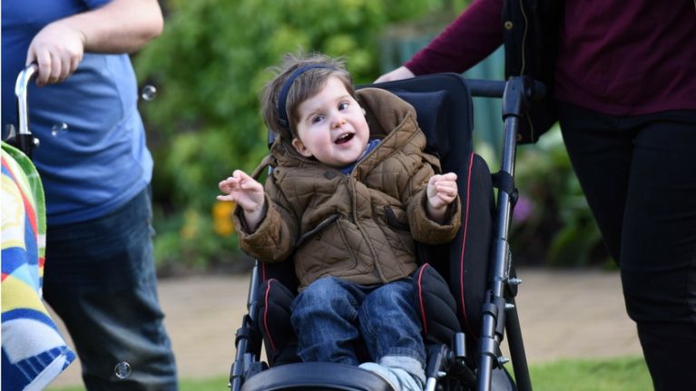 Young boy in wheelchair smiling