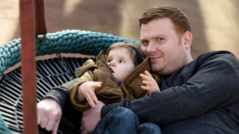 Boy with dad on swing