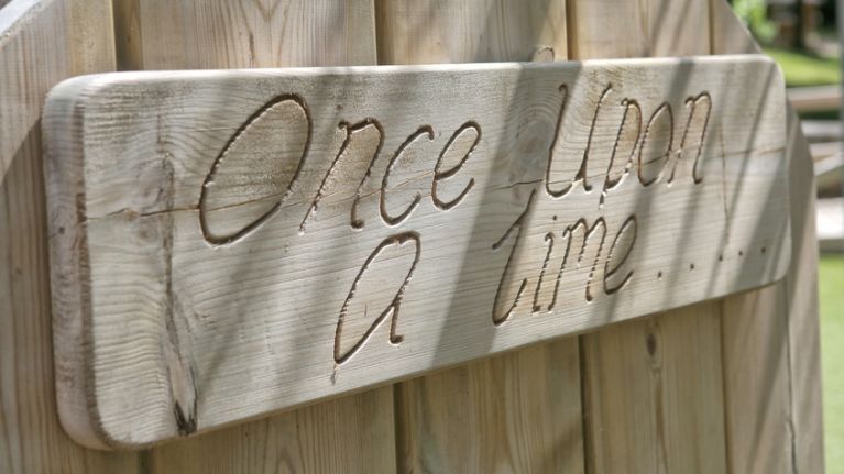 Wooden signpost with once upon a time etched into it