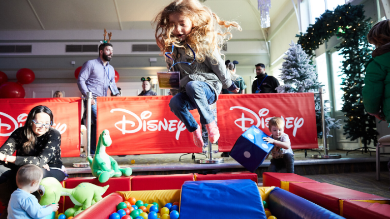 Girl jumping in ball pit