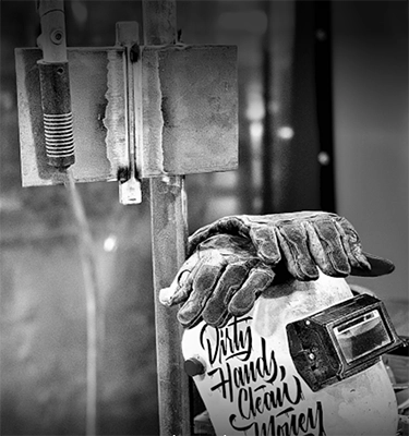 Welding helmet and gloves in black and white