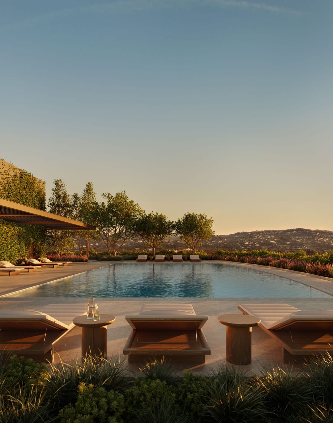 Rendu de la terrasse piscine des Aman Residences Beverly Hills au coucher du soleil, avec vue sur les collines