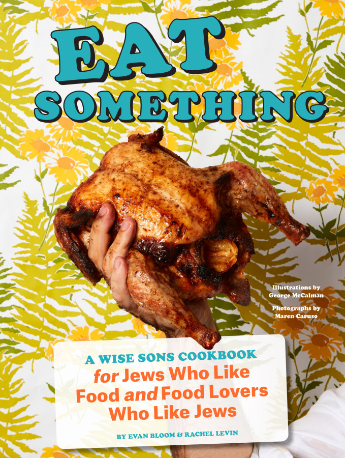 Cover of the cookbook with a photo of a chicken in the grip of a man's hand