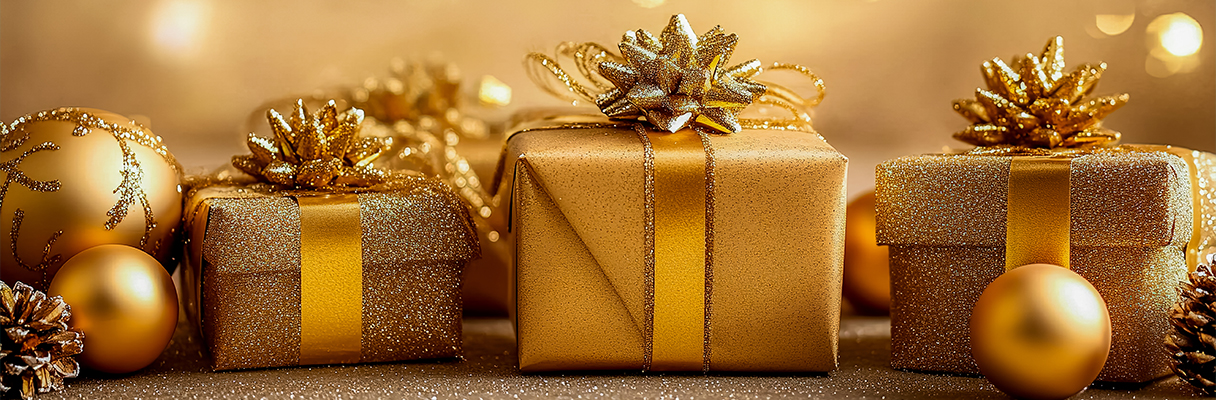 Three golden wrapped presents with golden baubles for 50th wedding anniversary Christmas gift celebration