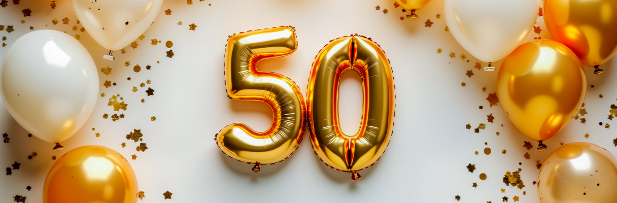 White and gold balloons with large gold number 50 ballons in the centre for 50th wedding anniversary party celebration