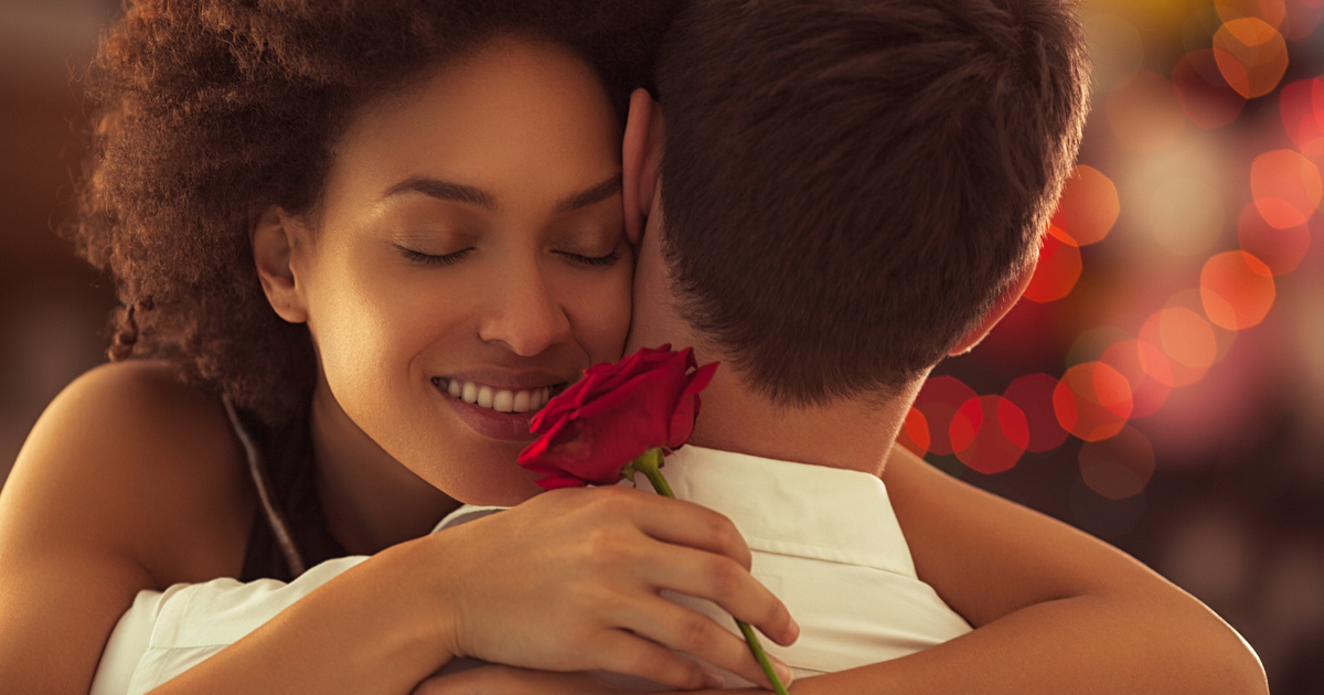 girl hugging her valentine while holding a rose girl hugging her valentine while holding a rose
