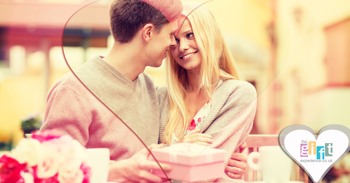 man giving his partner a valentine's day gift man giving his partner a valentine's day gift