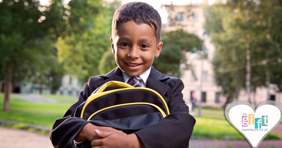 a little boy in a school uniform with a backpack all ready for school a little boy in a school uniform with a backpack all ready for school