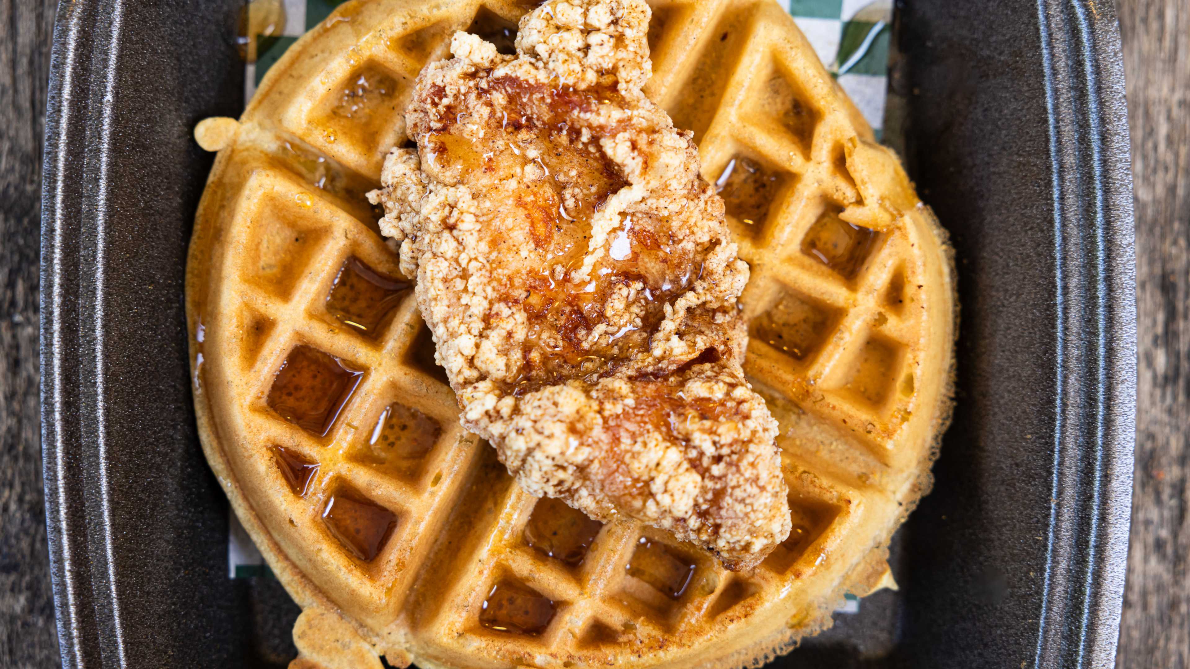 Fried chicken on top of a huge waffle.