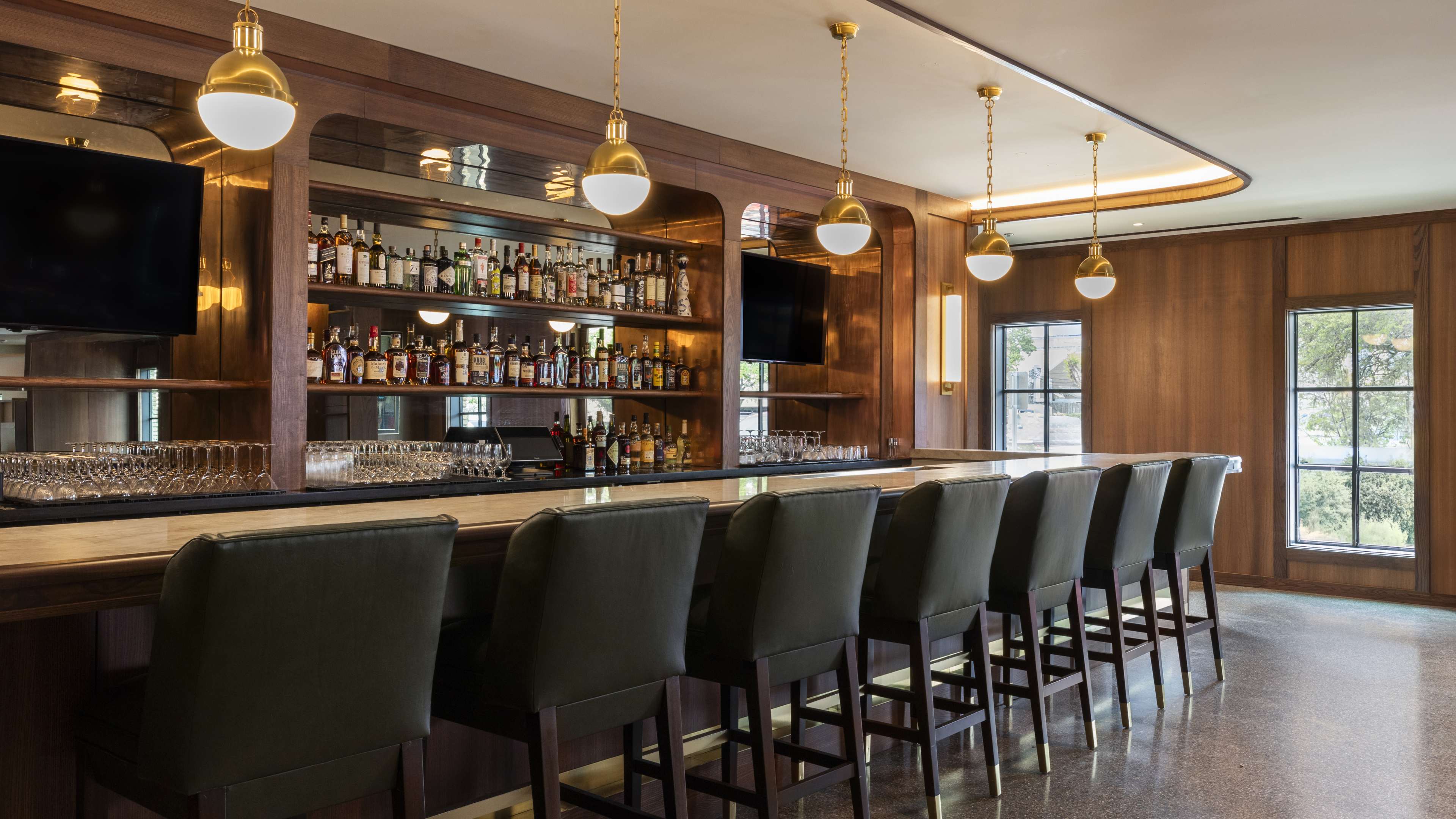 dark wood bar with vintage gold pendant lights at Bar Bludorn