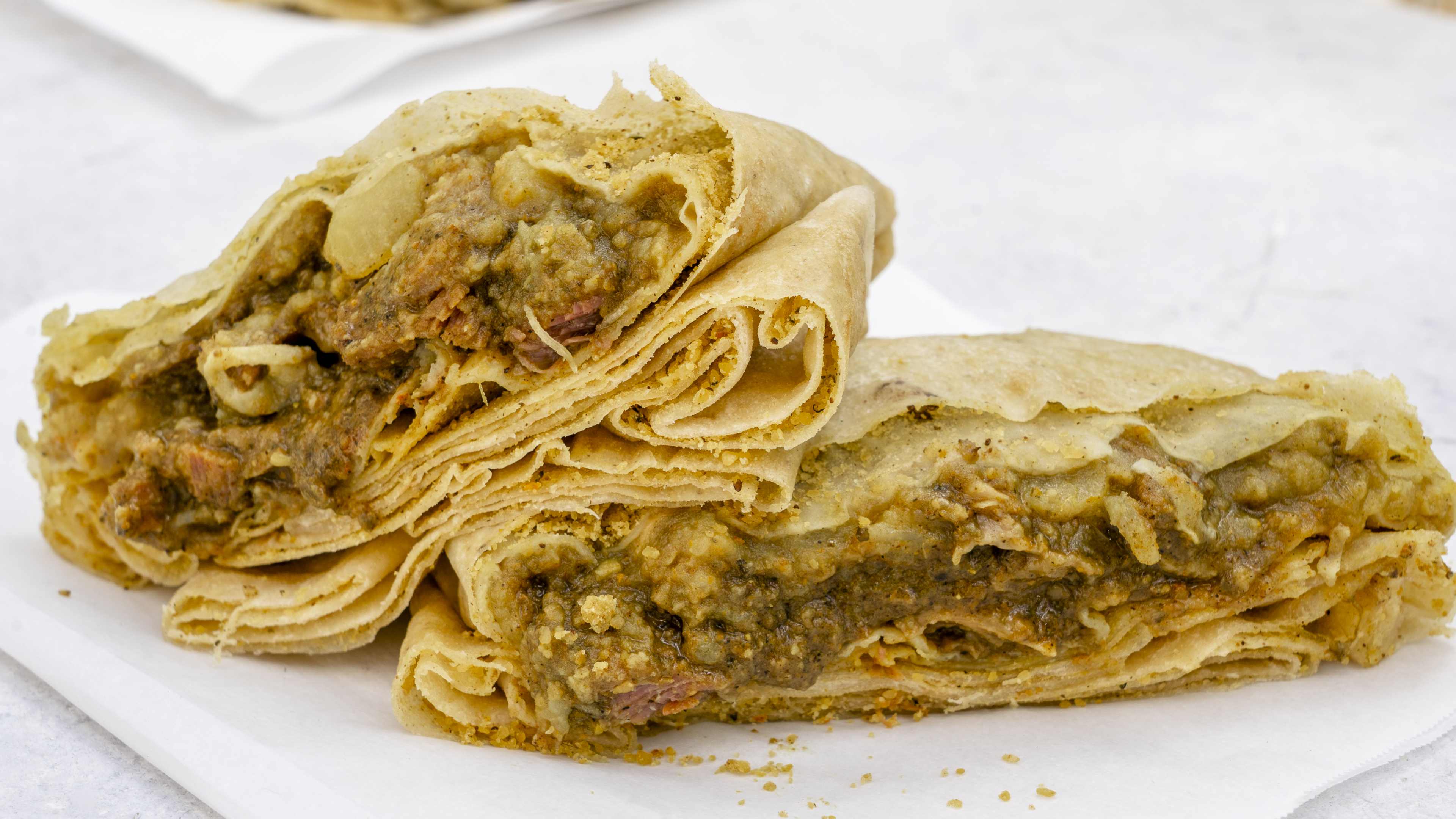 A goat roti cut in half, so you can see the cross-section.