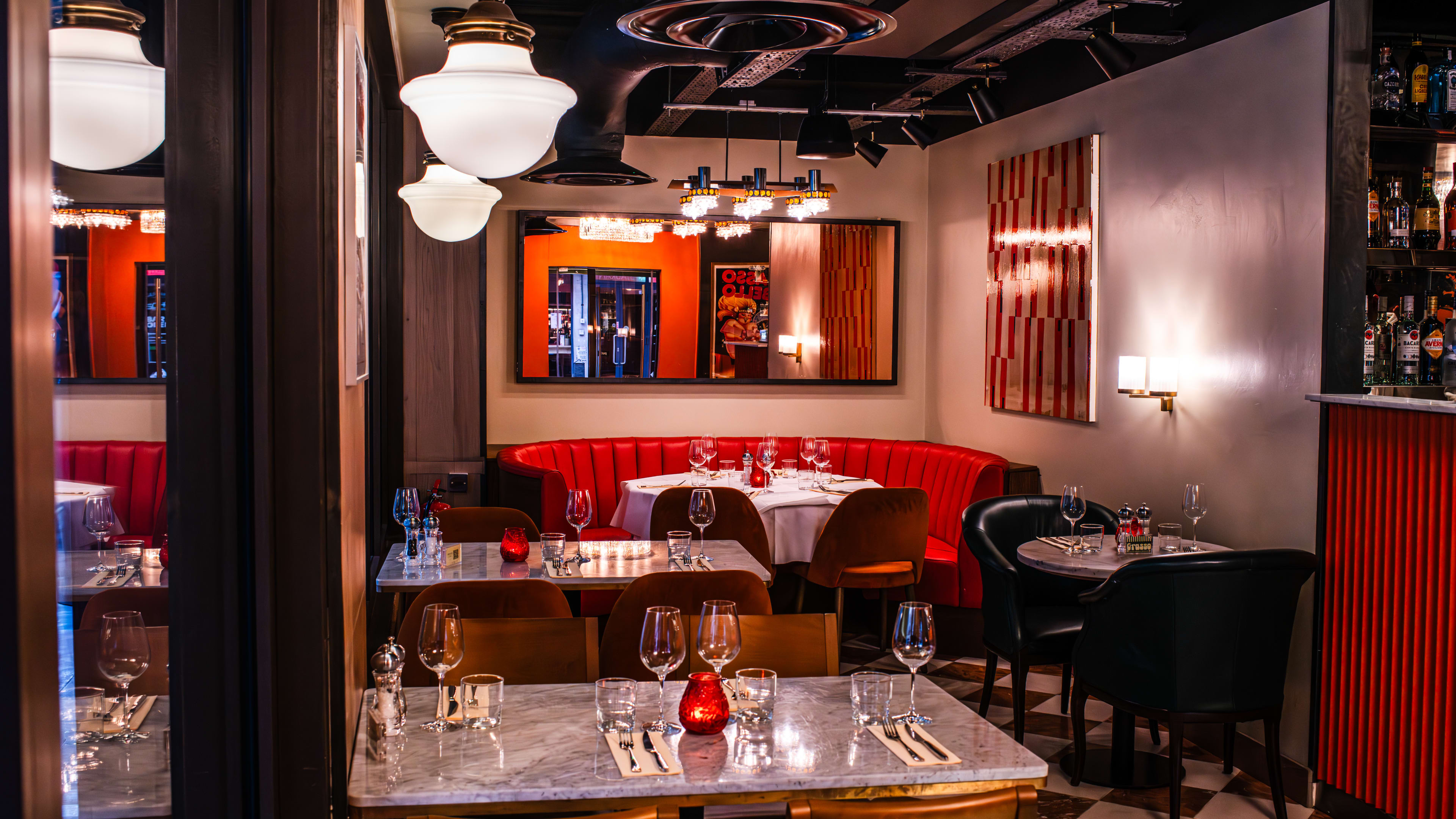 Interior of a restaurant with red booths.