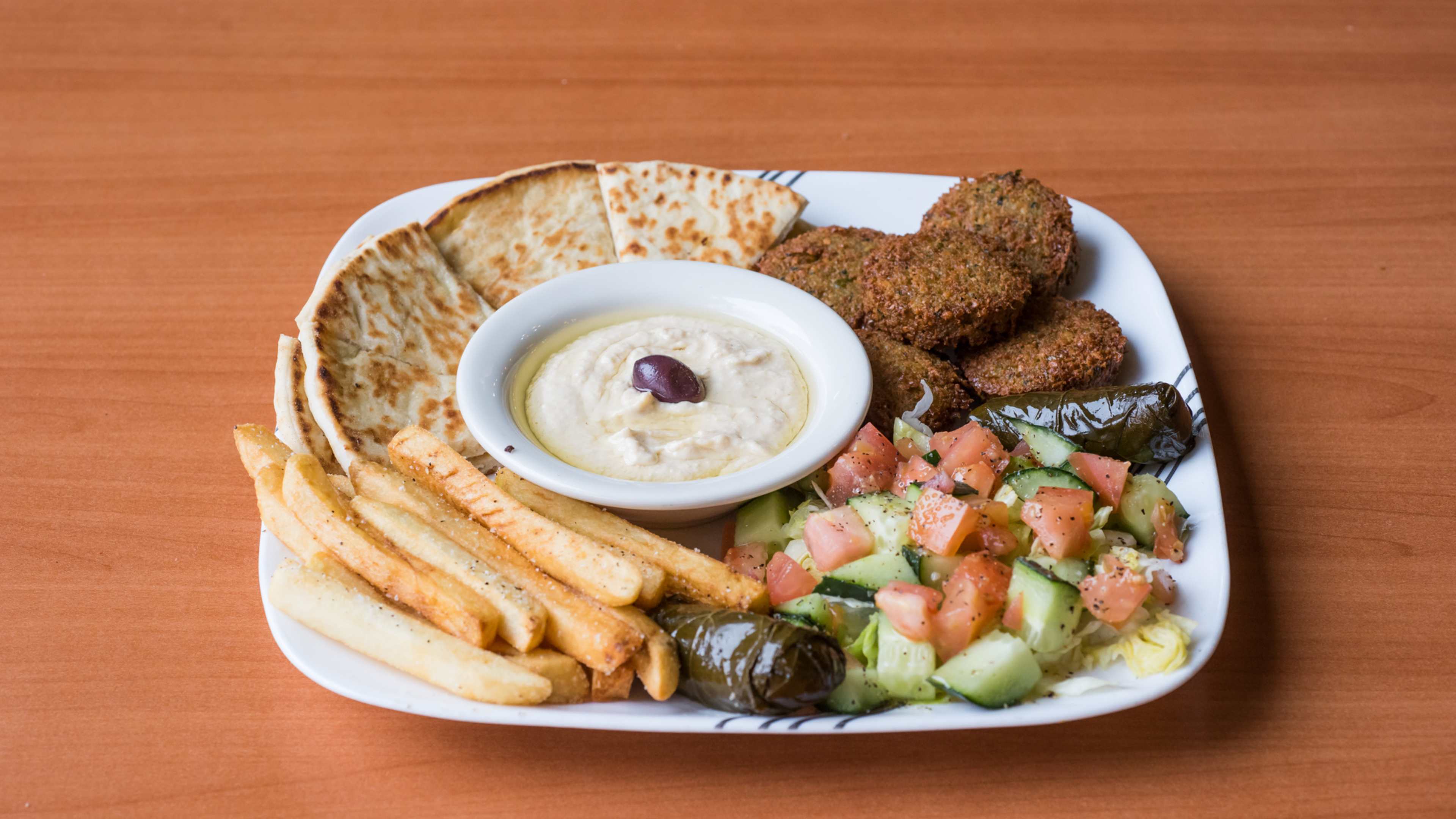 falafel platter with pita, hummus, and cucumber tomato salad