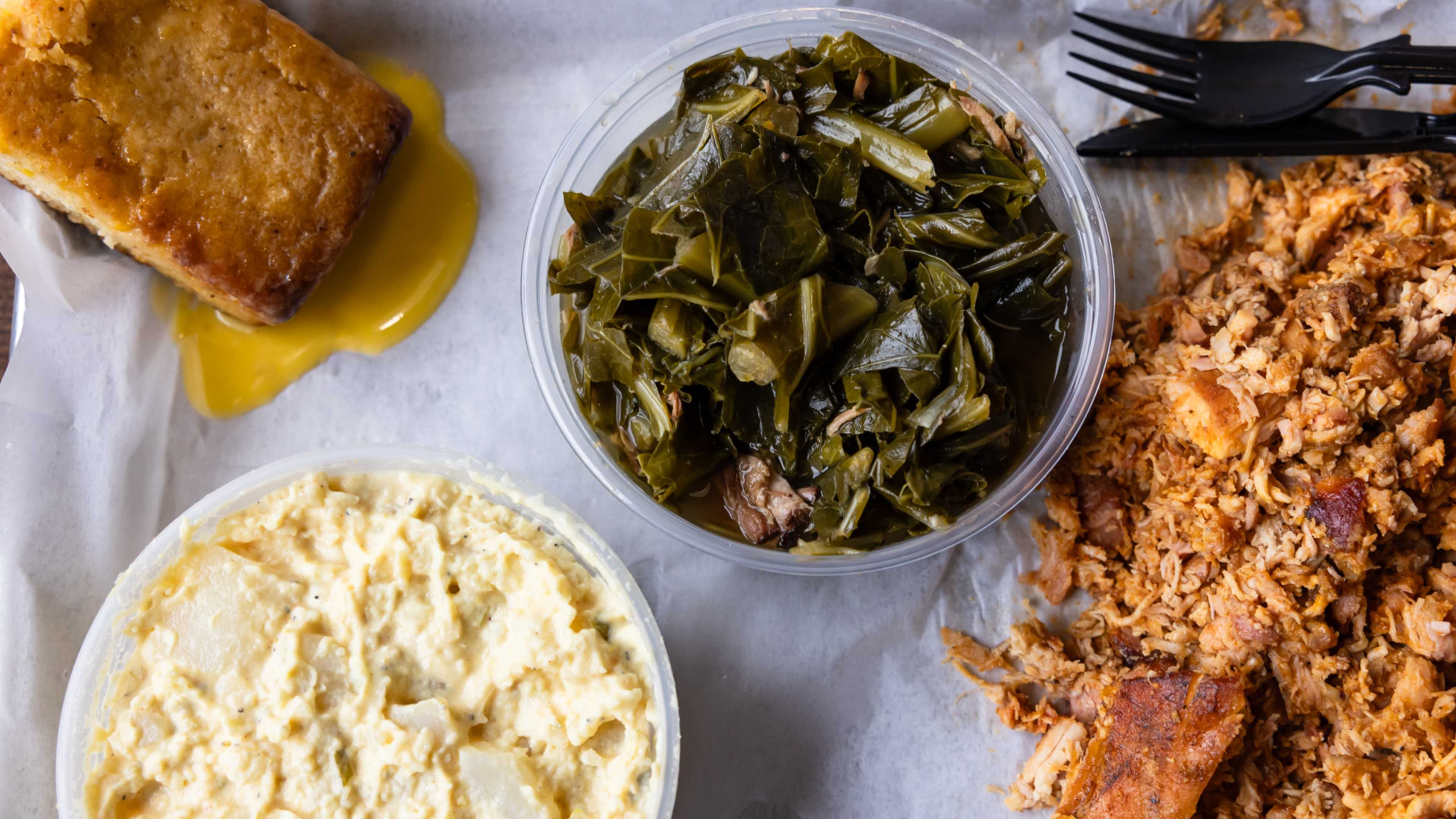 BBQ chicken, greens, potato salad, and cornbread.