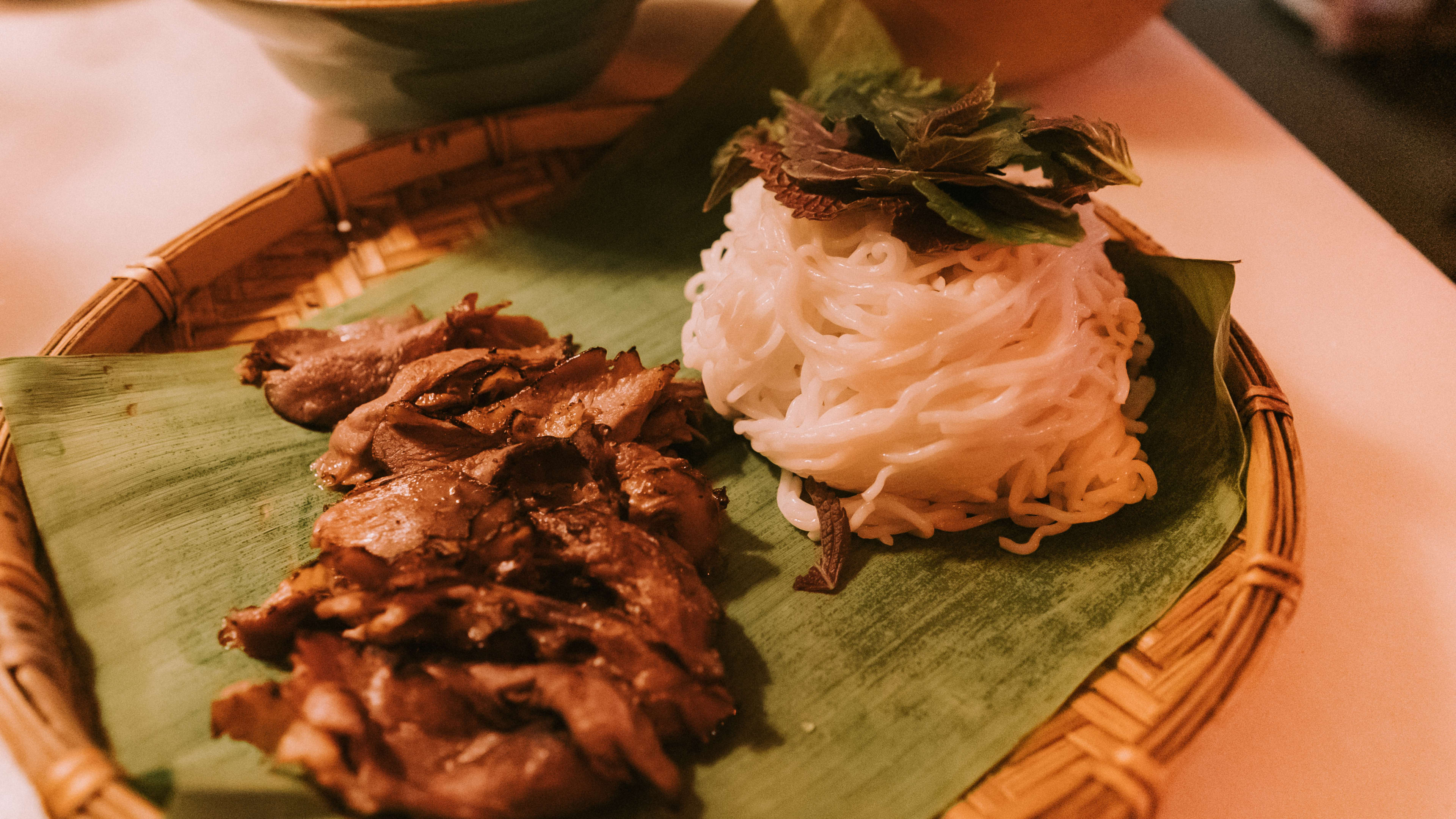 Bun Cha grilled duck breast plated on a banana leaf at The Eaves