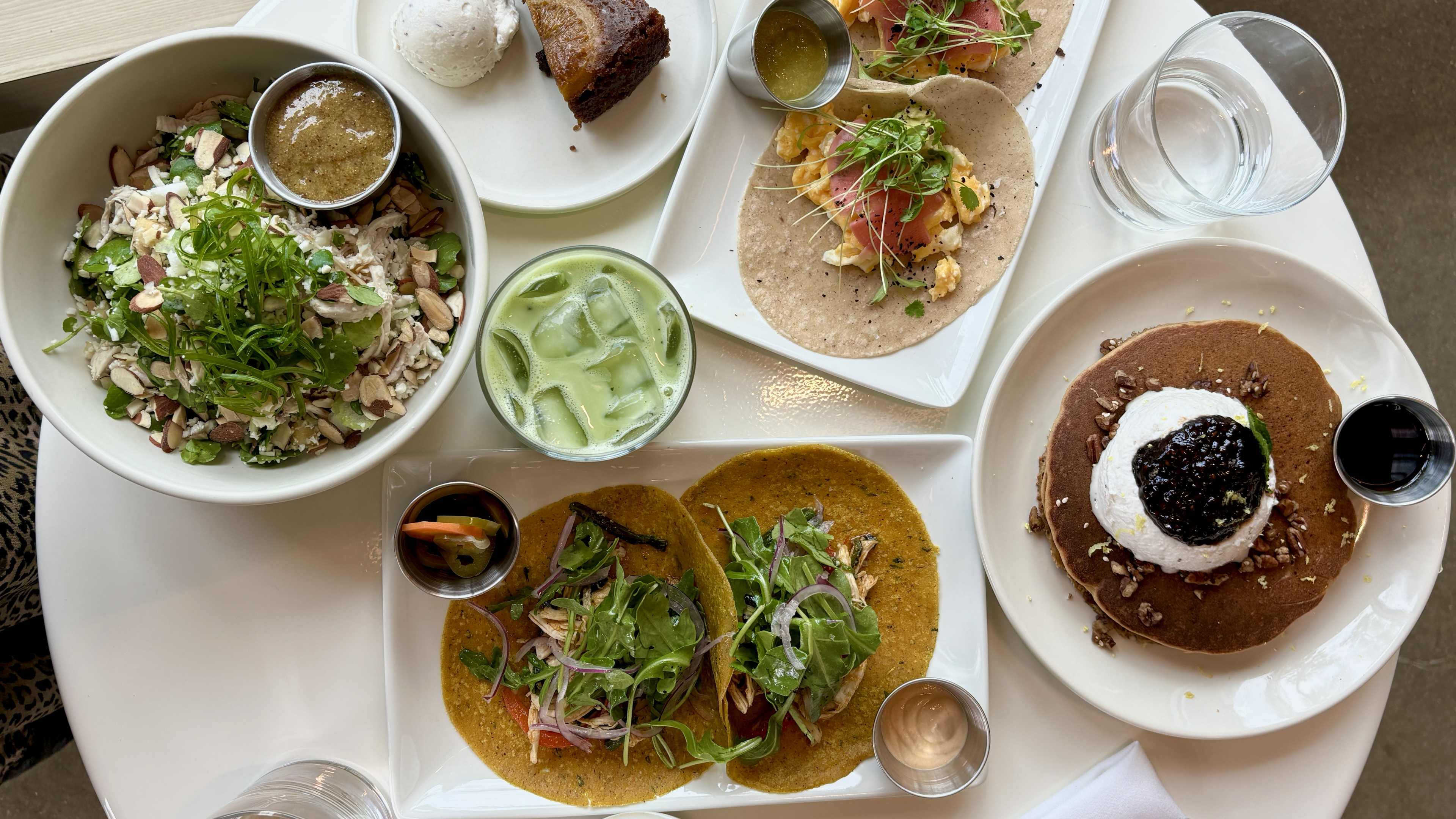 round table full of colorful plates of food and drinks at Vibrant