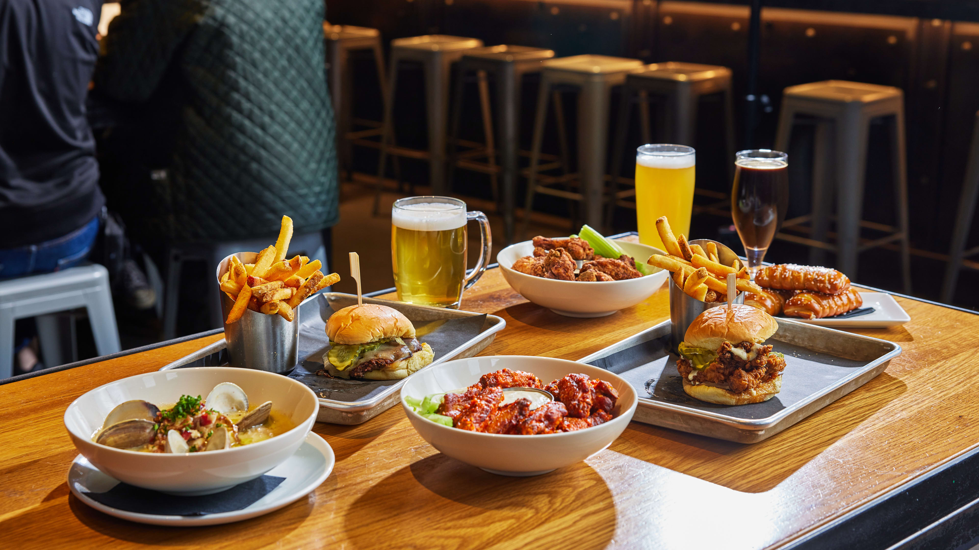 Spread of dishes and draught beers on wooden table at Trillium Brewing