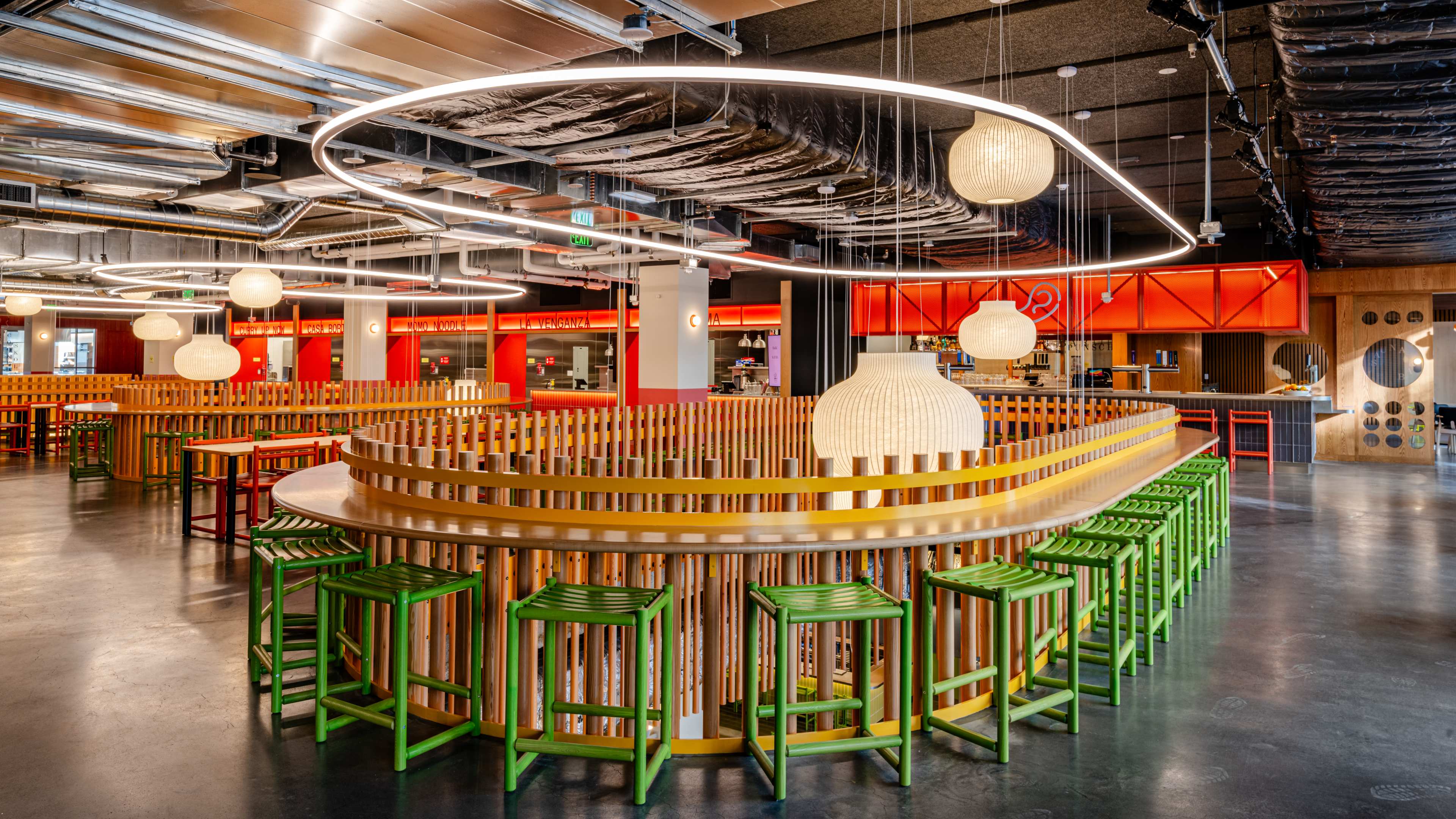 Green chairs and hanging lamps at Saluhall in SF.