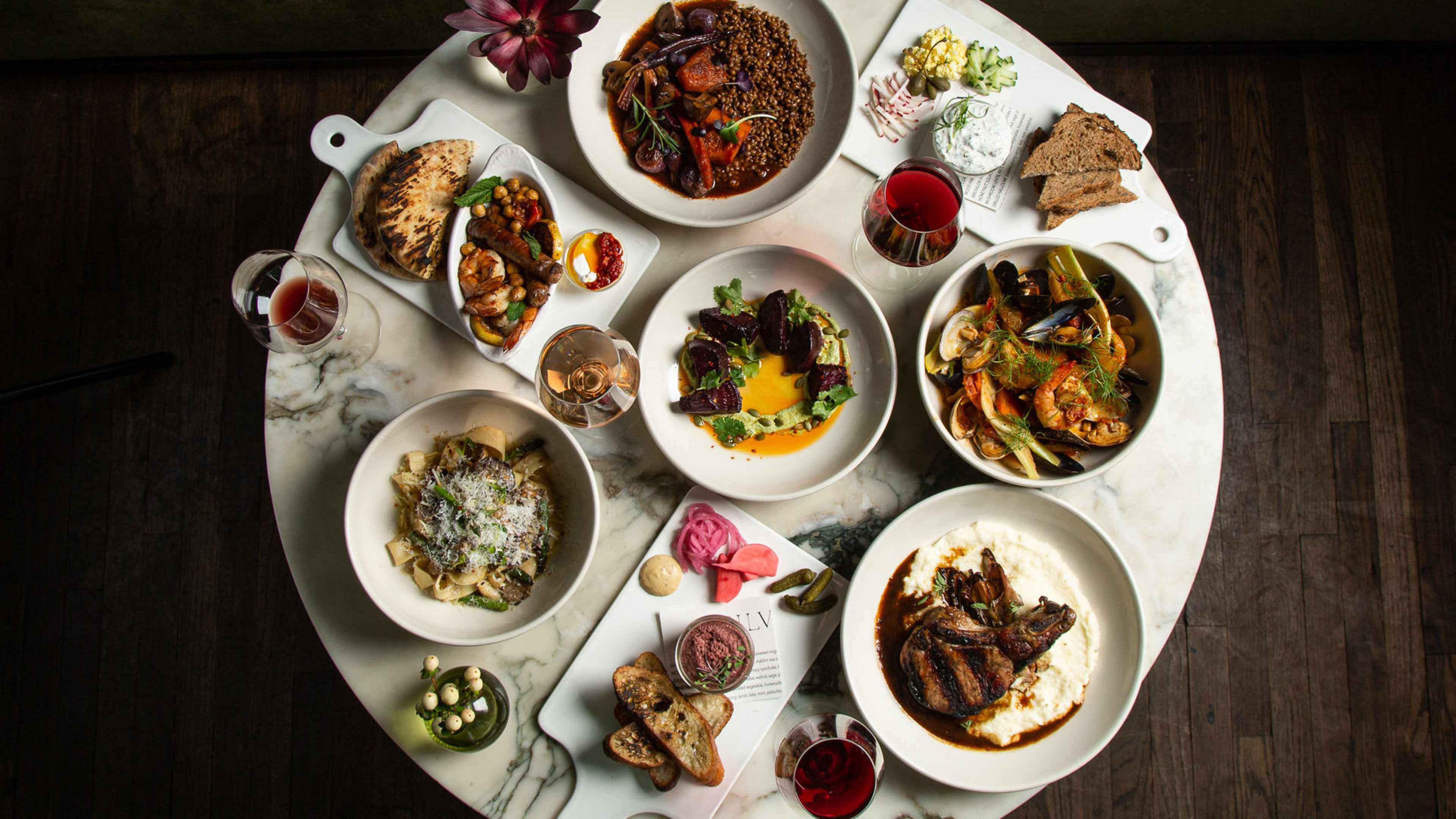 Silvia's dishes including steak, beet salad, bread, and pasta.