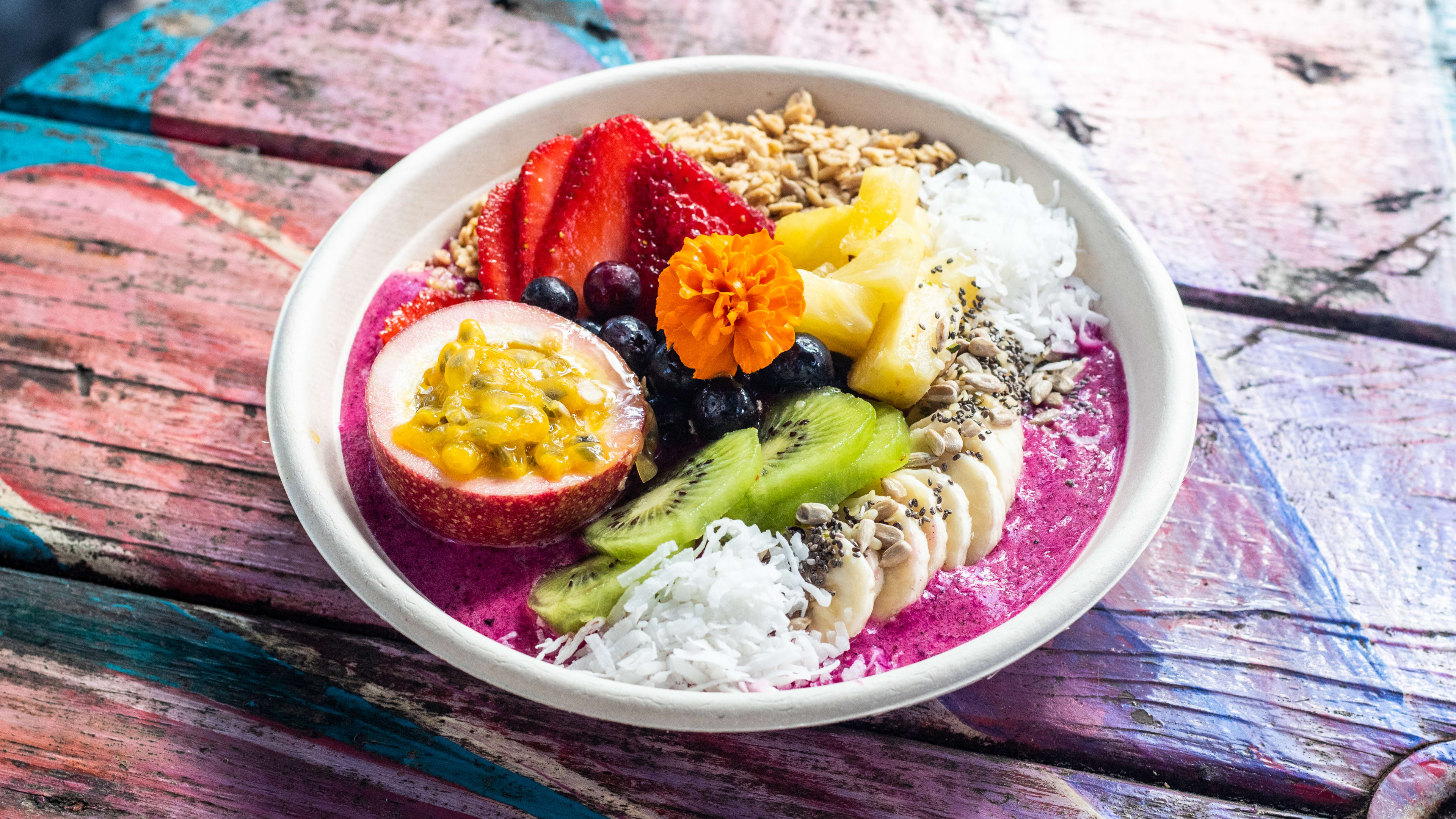 acai bowl topped with vibrant fruit and granola