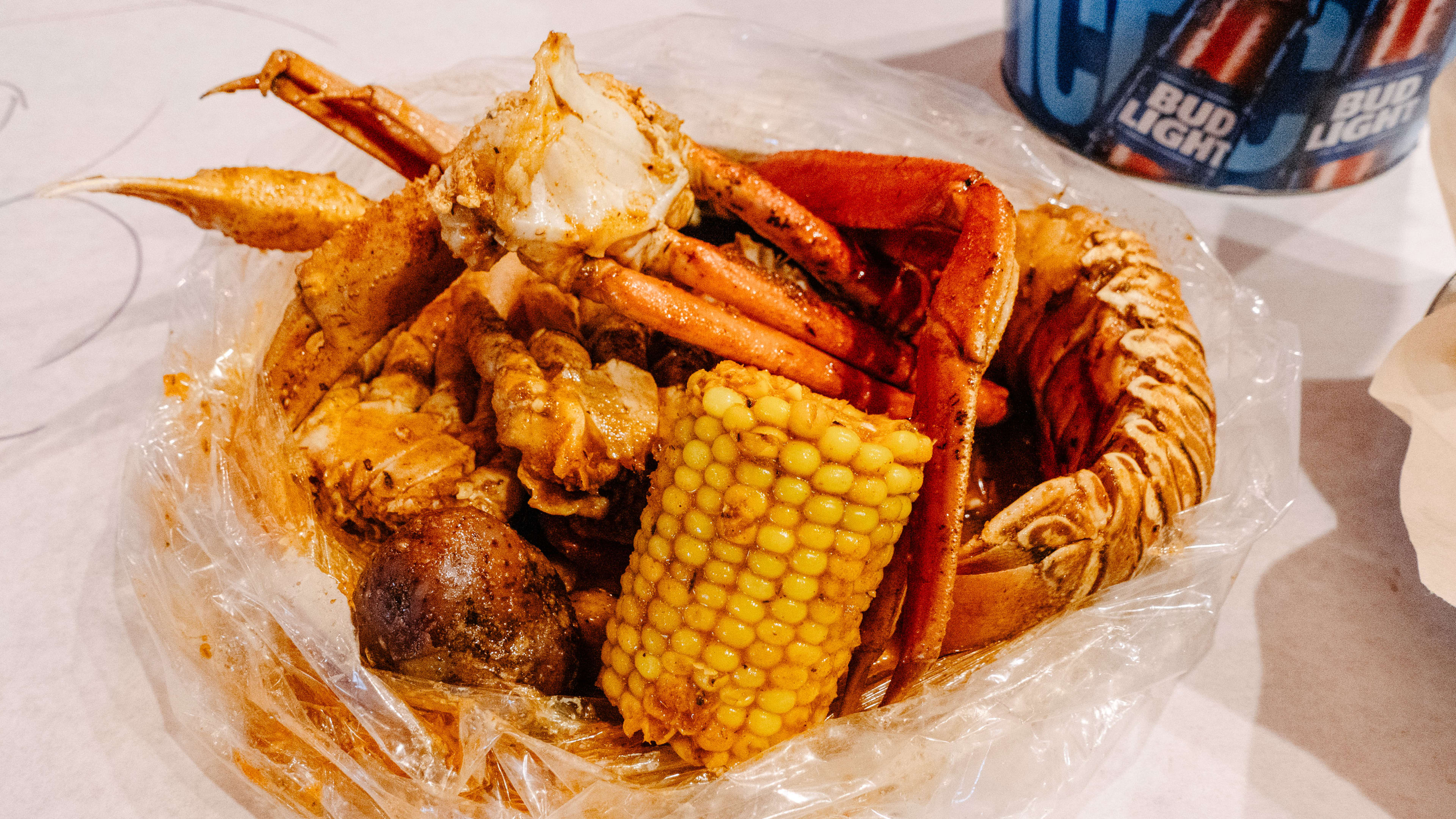 seafood boil with corn on the cob, crab legs, and lobster tail