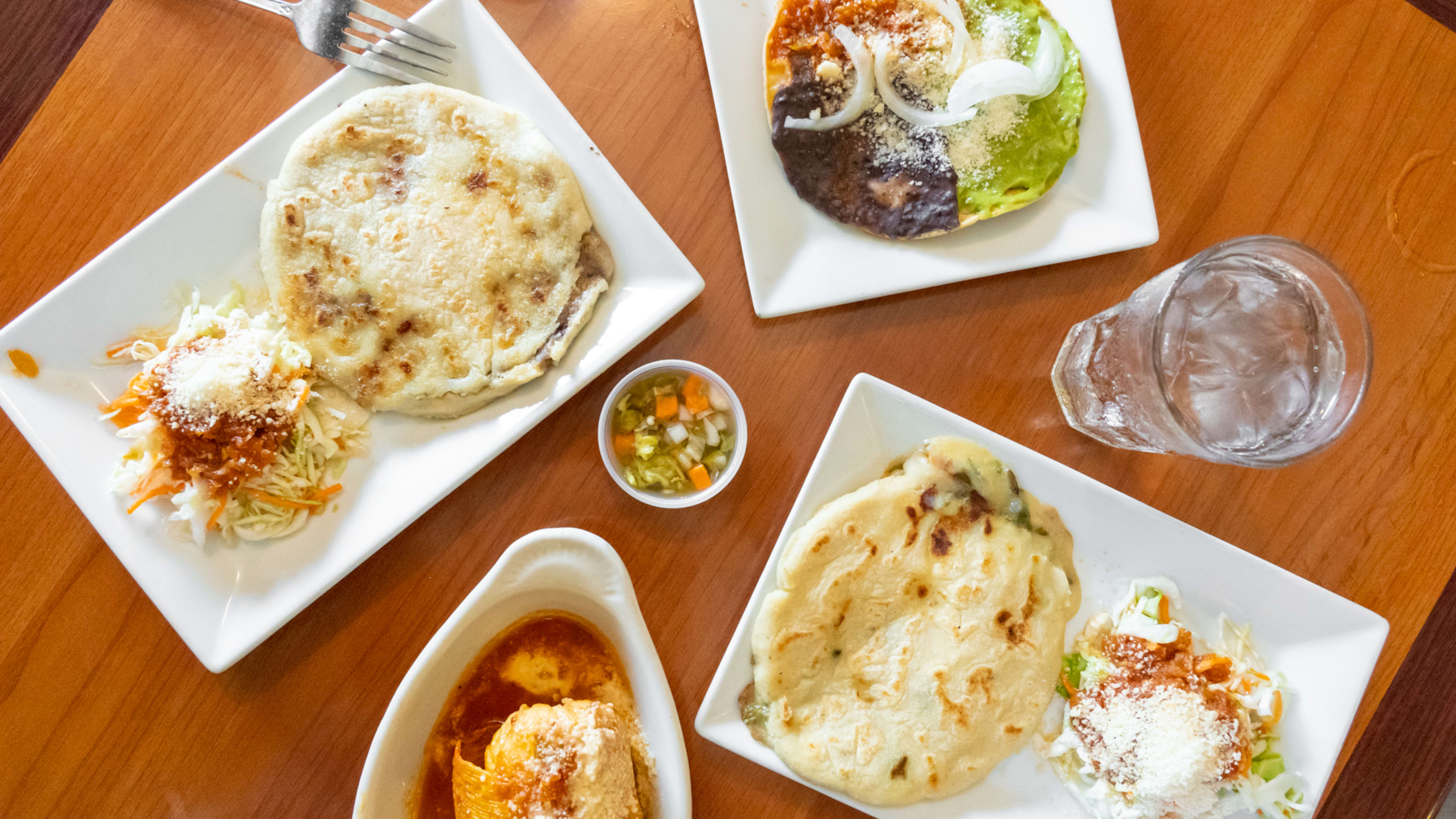 A spread of dishes on a wooden table.