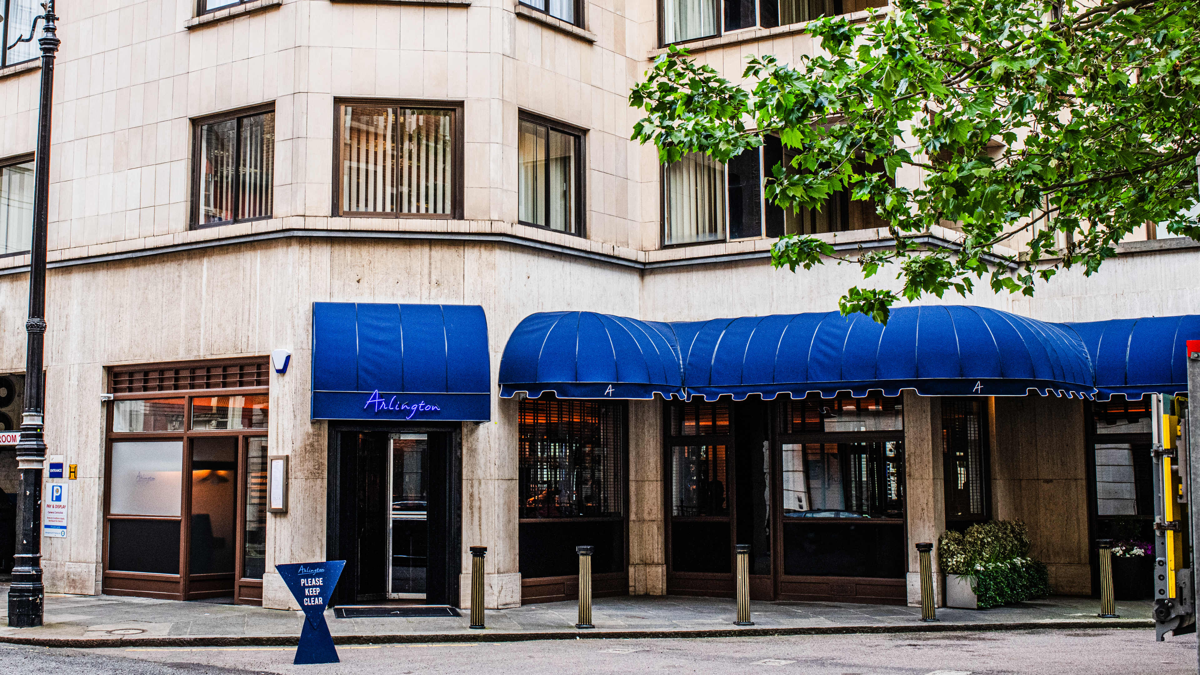 The exterior of Arlington with blue awnings.