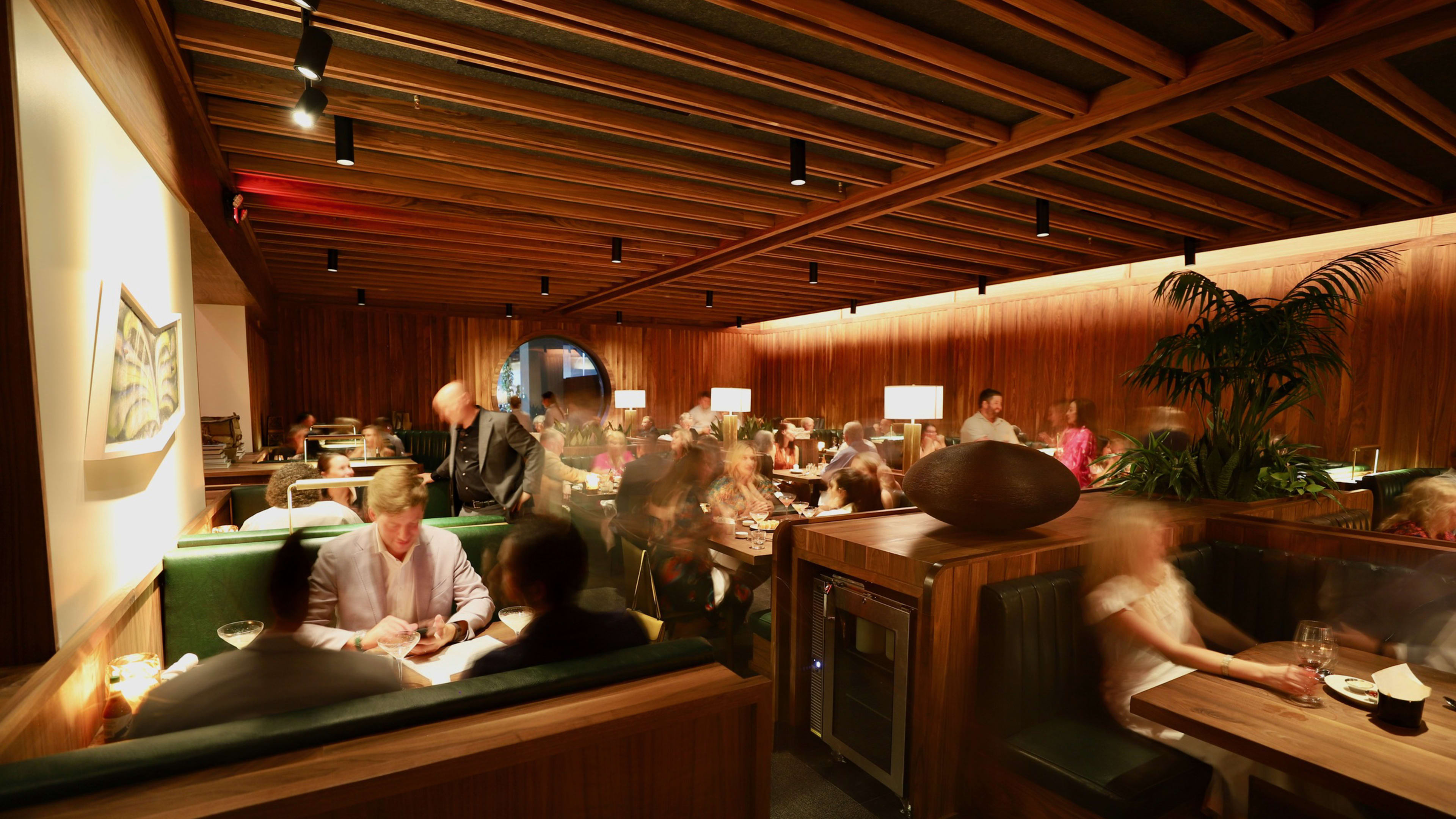 interior of balboa surf club with wooden panels and green booths